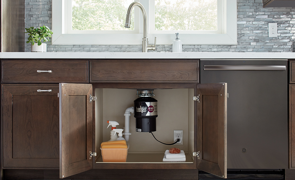Garbage disposal installation under a kitchen sink